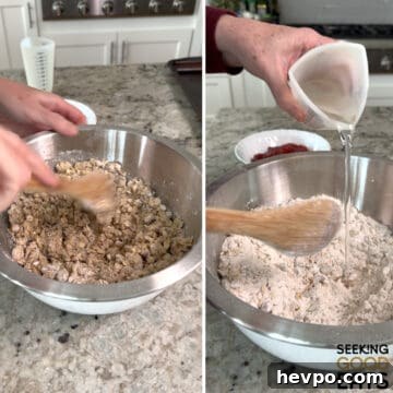 Mixing together the dry ingredients with the wet to make the crumble for strawberry oatmeal bars in a round silver bowl.