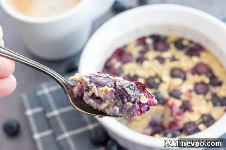 Single-Serve Baked Oats Recipe for One: Quick Breakfast Bowl 9 spoon lifting up some of the single serve baked oats