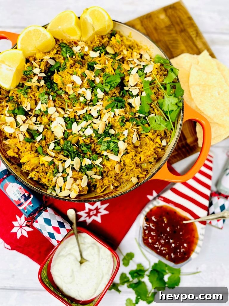 Leftover Turkey Biryani Recipe: Quick Flavorful Turkey Biryani 2 leftover turkey biryani served in an orange skillet pan. Bowl of Indian mint yogurt and mango chutney on the side along with some poppadoms