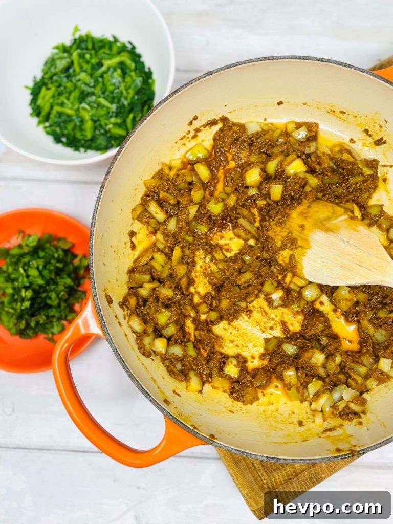 Leftover Turkey Biryani Recipe: Quick Flavorful Turkey Biryani 4 onions and curry paste being fried in a pan