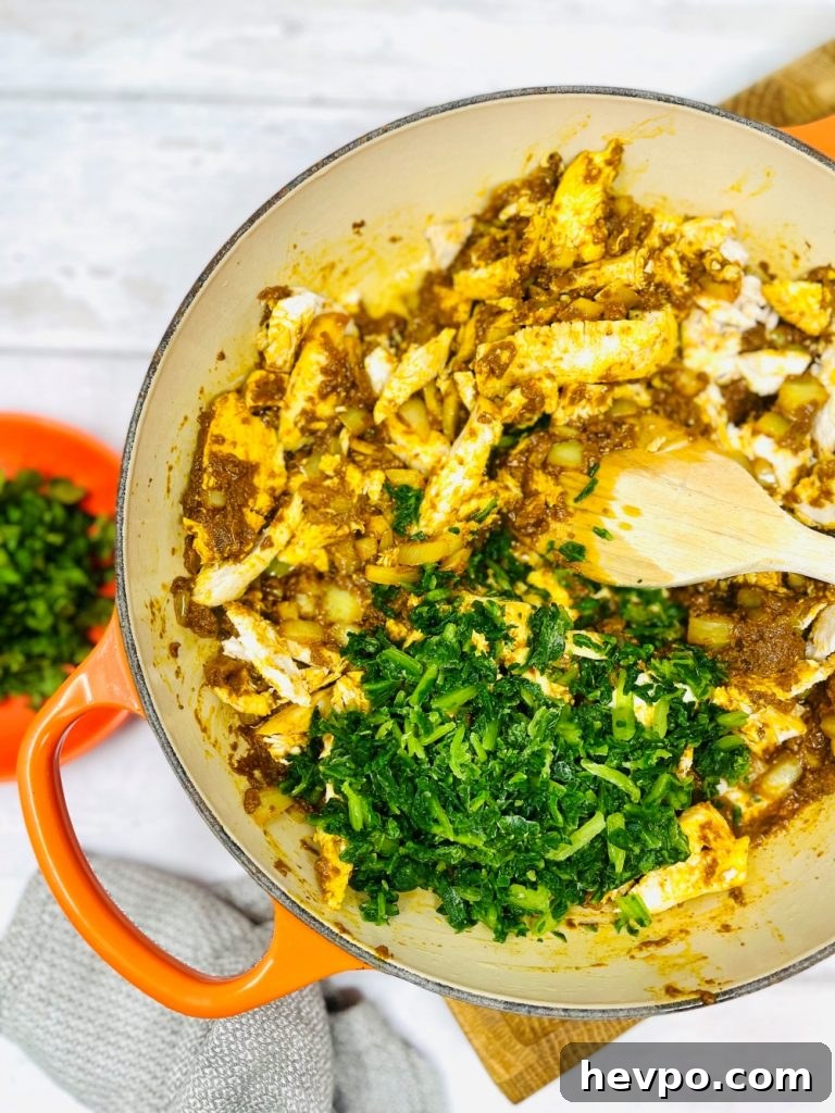 Leftover Turkey Biryani Recipe: Quick Flavorful Turkey Biryani 5 leftover turkey, onions and curry paste being fried in a pan - frozen spinach tipped in the middle