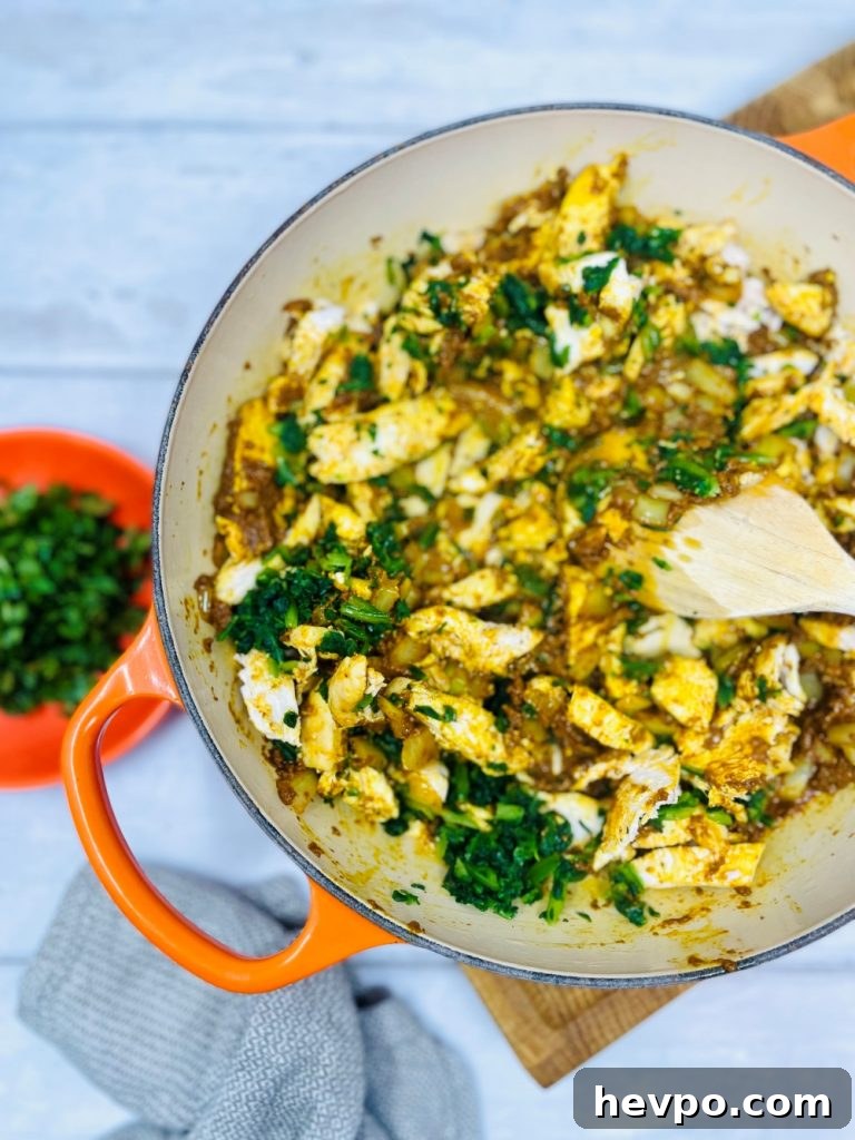 Leftover Turkey Biryani Recipe: Quick Flavorful Turkey Biryani 6 leftover turkey, onions, spinach, curry paste being fried in a pan