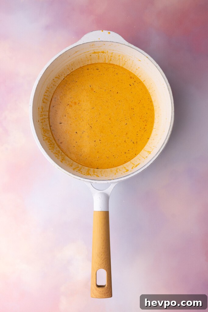 Cheese sauce for macaroni made with Cajun seasoning and sharp cheddar cheese.