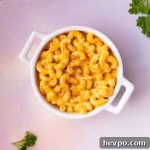 Small cocotte filled with Cajun Mac and Cheese on colorful background.