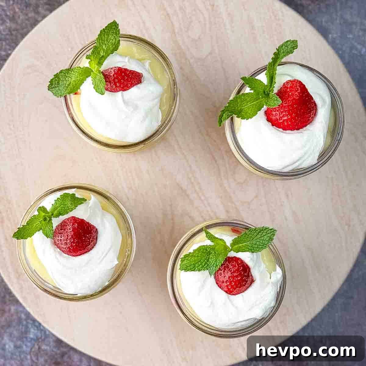 The tops of the parfaits garnished with strawberries and mint leaves.