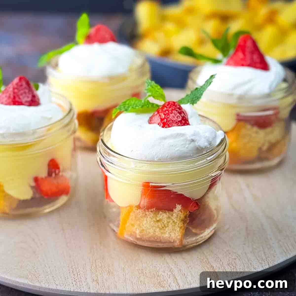 Jars of strawberry shortcake placed on a serving platter.