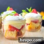 Jars of strawberry parfaits on a serving tray, ready to be served.