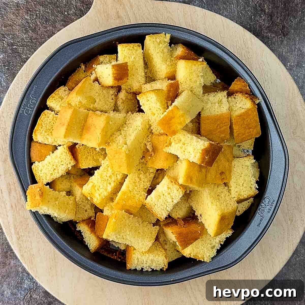 The cake cut into cubes and placed back in a round baking dish.