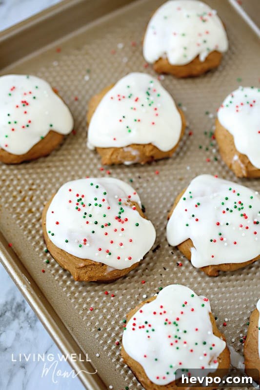 Gluten-Free Frosted Ginger Cookies Recipe — Soft, Spiced Treats 4 fresh ginger cookies on a cookie sheet