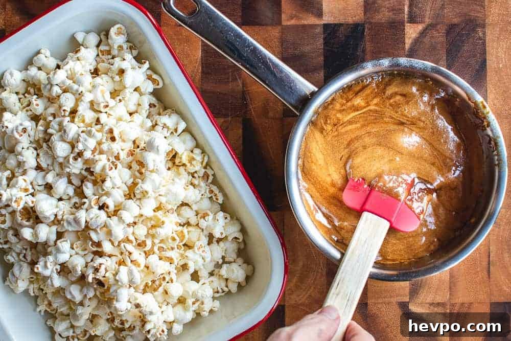 A pot of caramel and a tray of popcorn shown from overhead.