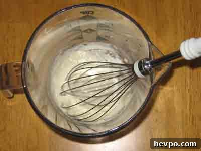 Whisk a little water into 1 TB flour.