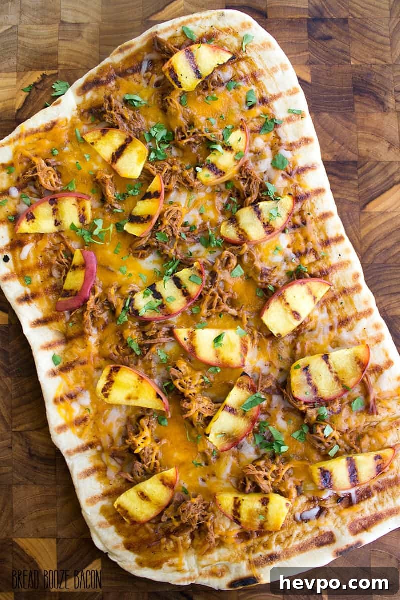 Grilled BBQ Pulled Pork and Peach Pizza Recipe 4 Grilled BBQ Pulled Pork & Peach Gourmet Pizza Recipe is one of those bites of food bliss you just can't stop eating! I love the combination of luscious, fatty pork with fresh peaches and cilantro!