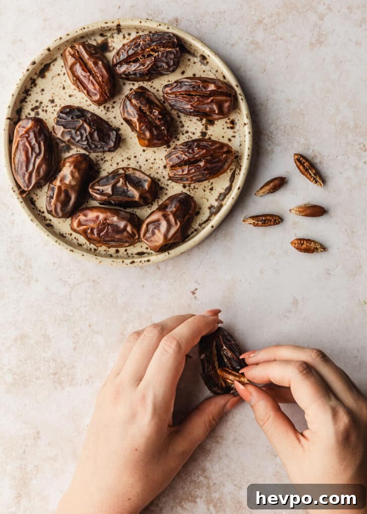 Prosciutto-Wrapped Dates with 3 Simple Ingredients 6 Hands removing the pit of a date on a tan counter.