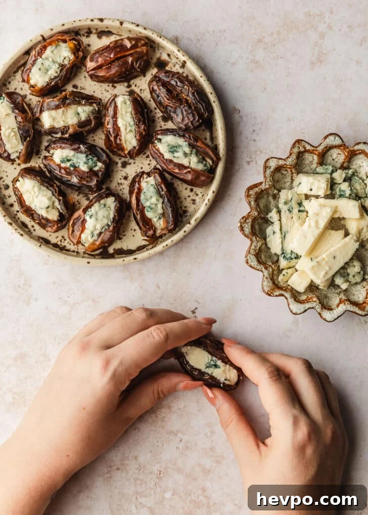 Prosciutto-Wrapped Dates with 3 Simple Ingredients 8 Hands assembling blue cheese stuffed dates on a tan counter next to brown bowls of blue cheese and dates.
