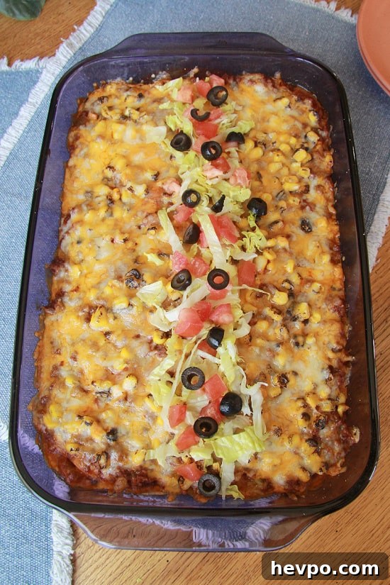 Beef Enchilada Casserole has ground beef, enchilada sauce, salsa, corn, and lots of cheese. A 13 x 9" dish filled with a hearty satisfying meal made with ground beef, cheese, corn, and tortillas.