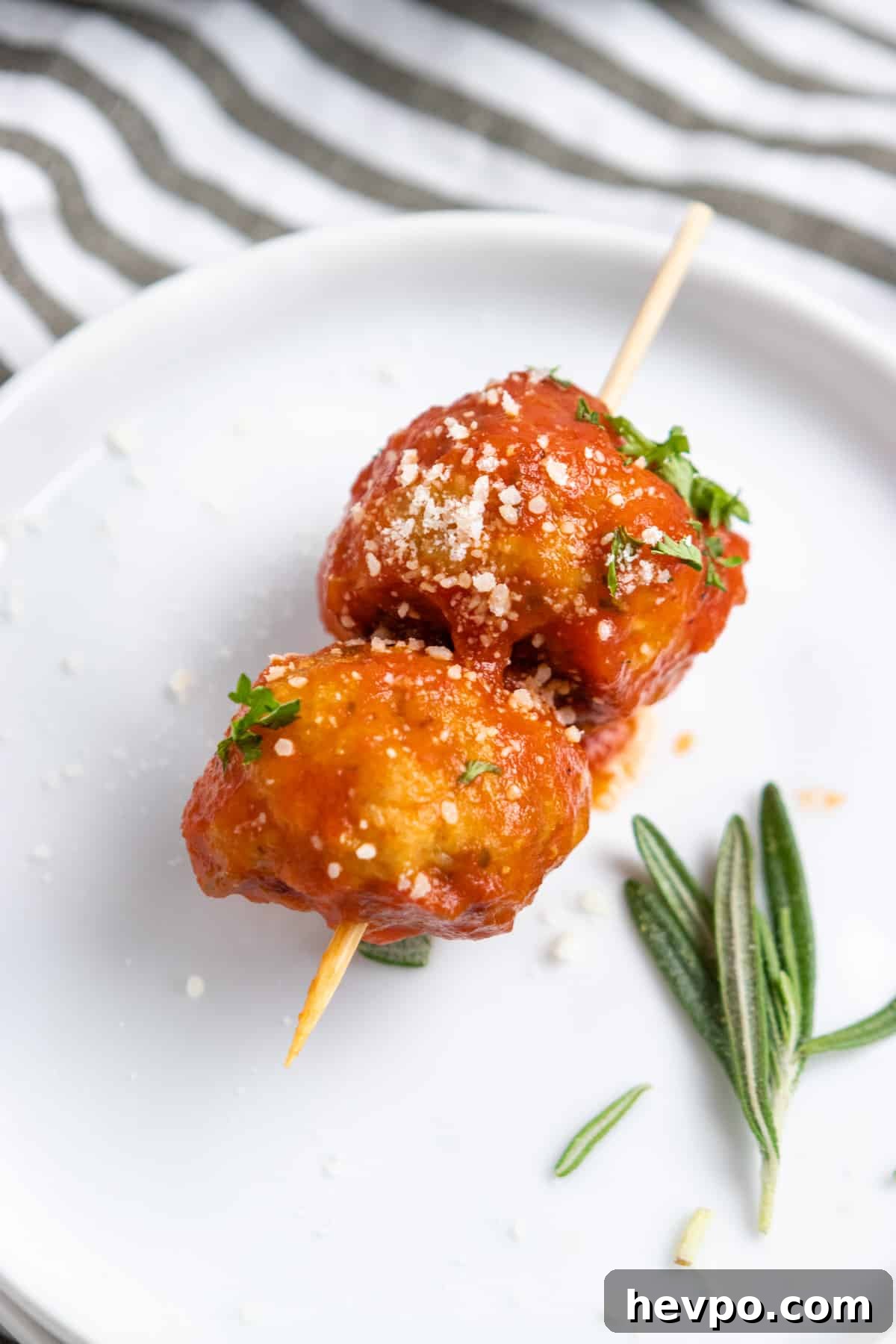 Meatballs with marinara on skewer.