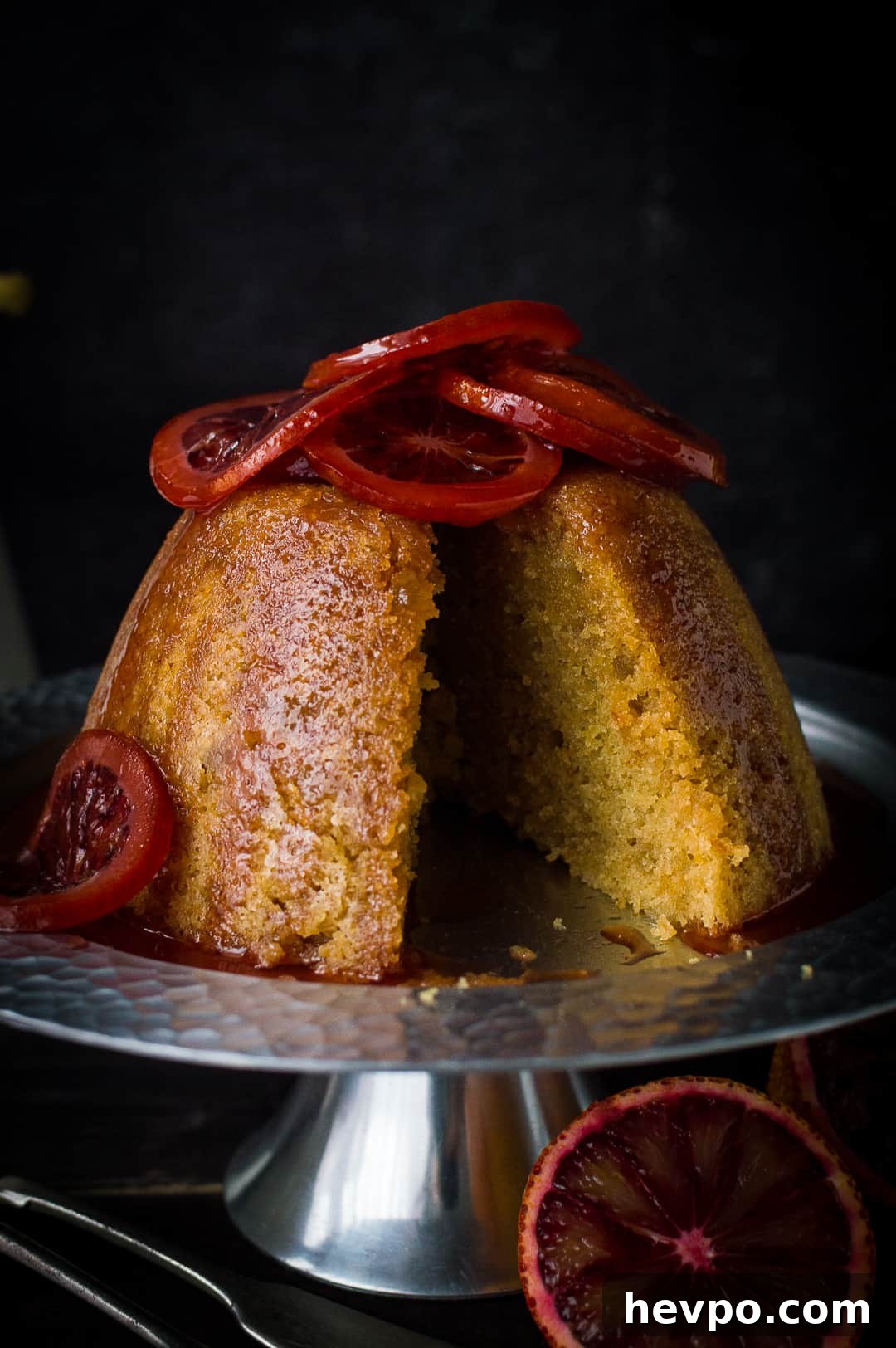 Close-up of sliced slow cooker blood orange and ginger steamed pudding.