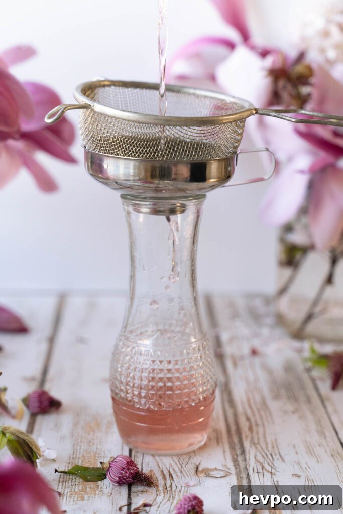 Magnolia Flower Syrup Recipe & Uses for Flavor and Wellness 7 Straining magnolia flower syrup