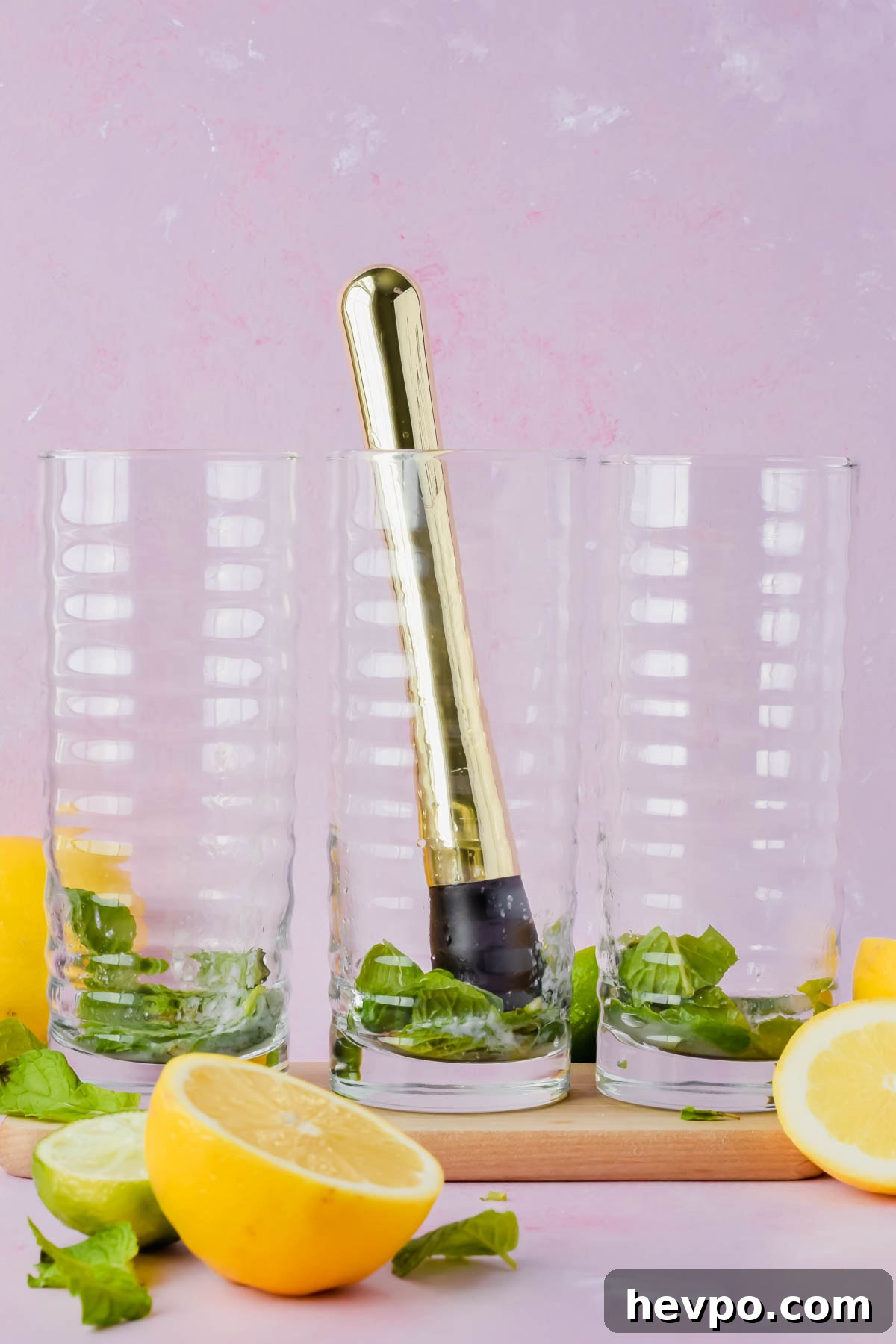 Lemonade Mojito Recipe: Refreshing Low-Calorie Twist 6 gold muddle in middle glass pressing on fresh mint and lime juice.