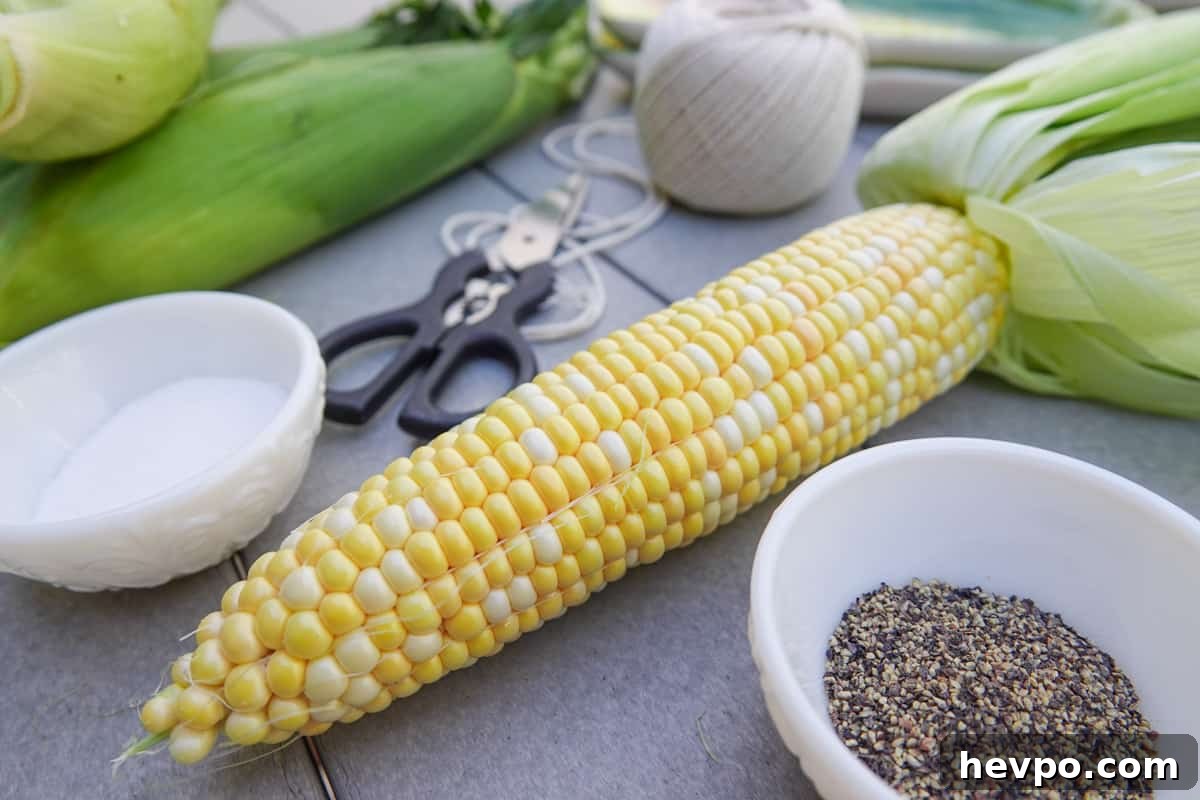 Smoked Corn on the Cob with Garlic Butter Glaze 2 Ear of corn on table with salt and pepper