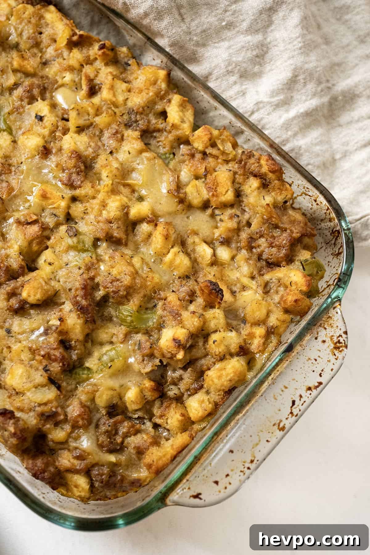 Italian sausage stuffing baked in a glass baking pan.