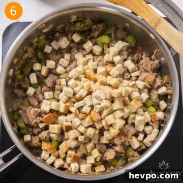 Bread stuffing cubes added to browned sausage.
