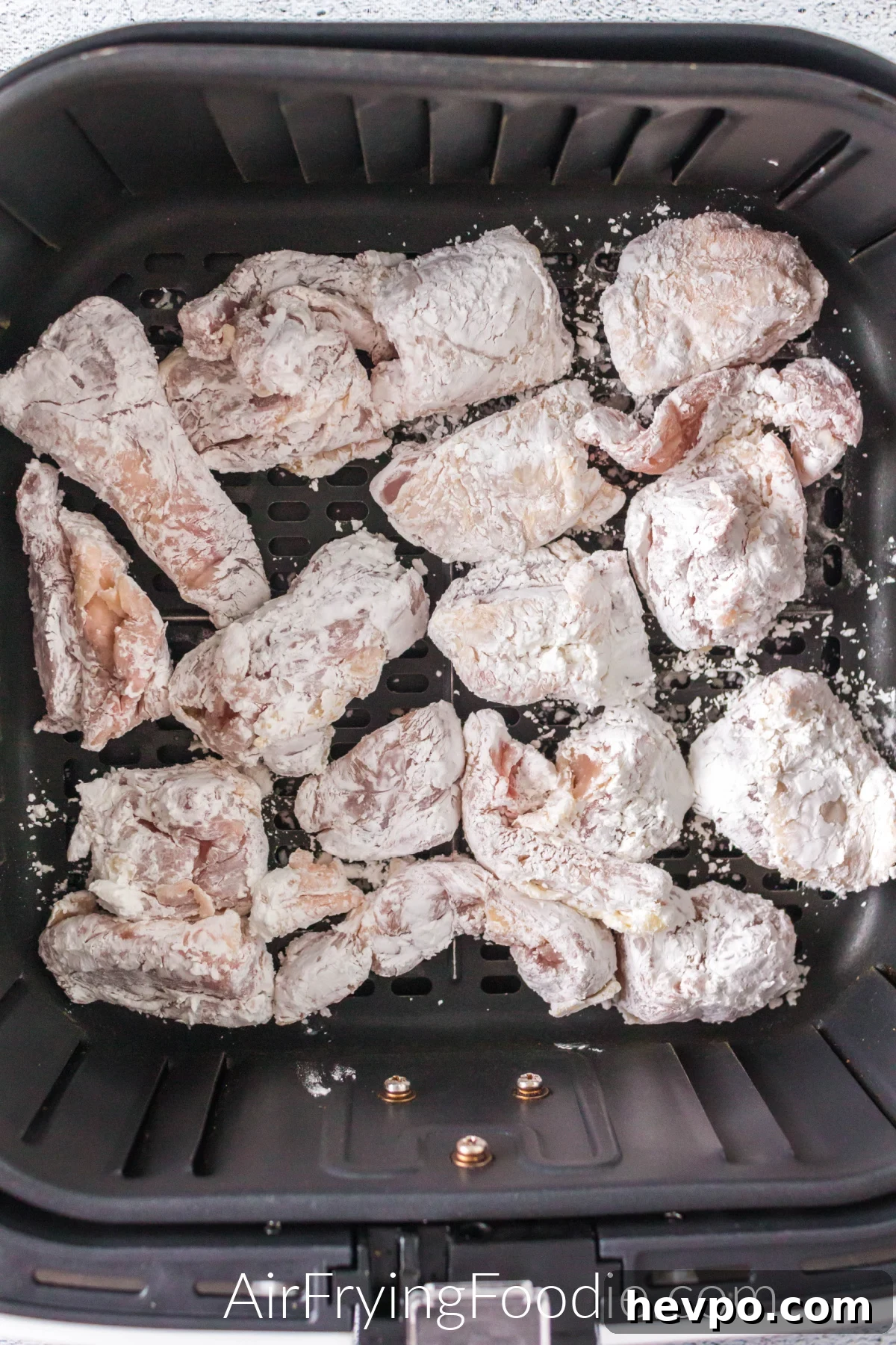 Coated chicken in the basket of the air fryer