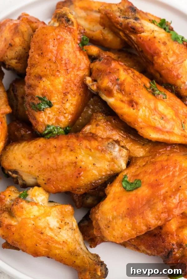 Crispy Air Fryer chicken wings on a white plate ready to serve.