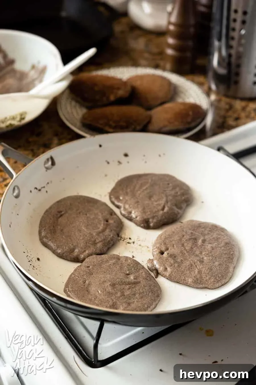 Gluten-Free Buckwheat Pancakes for a Spooky Halloween Breakfast 6 Buckwheat pancakes cooking in a pan