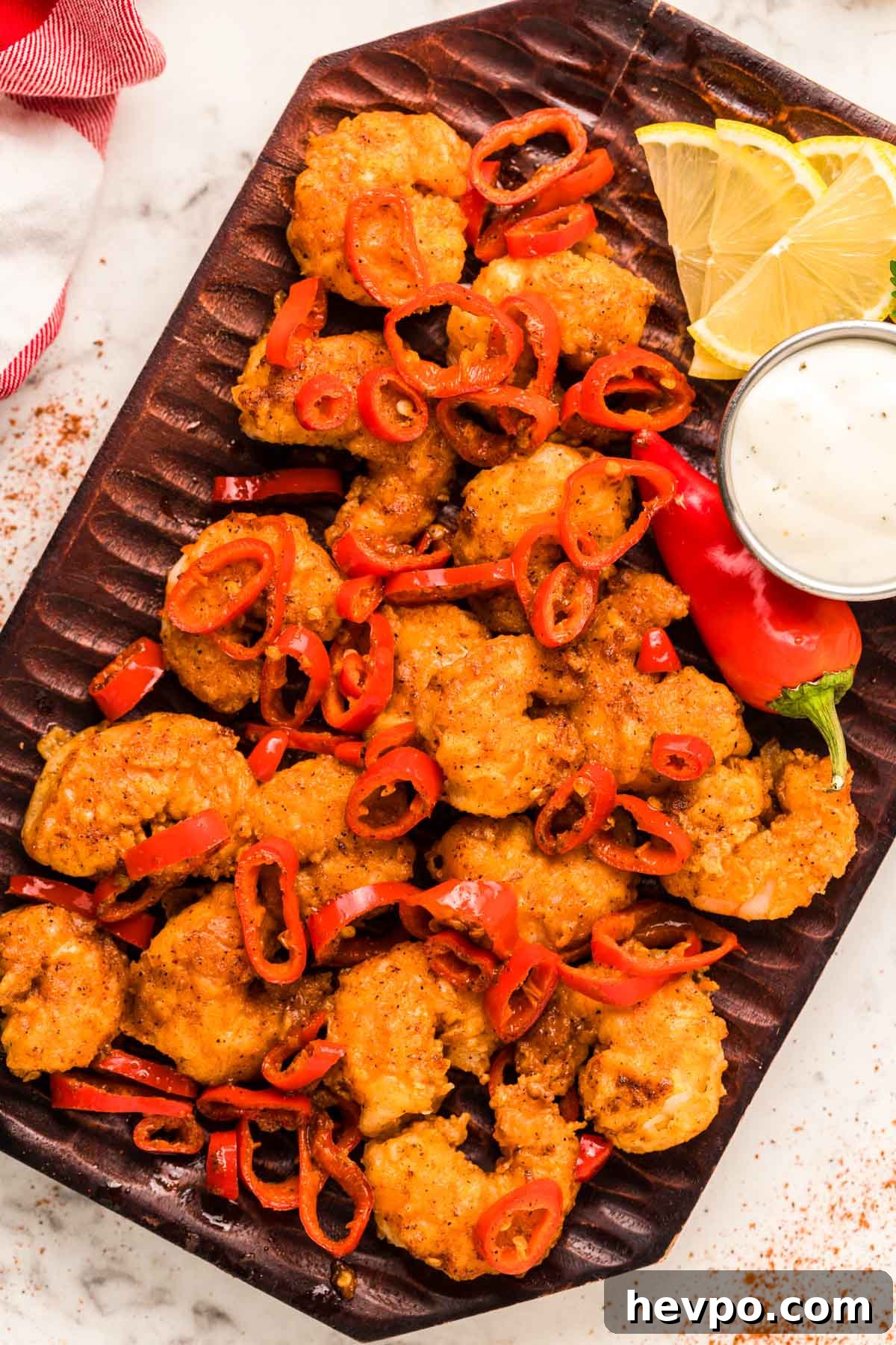LongHorn-Style Wild West Shrimp Recipe: Copycat Steakhouse Dish 2 Overhead photo of Longhorn Wild West Shrimp copycat recipe on a wooden plate.