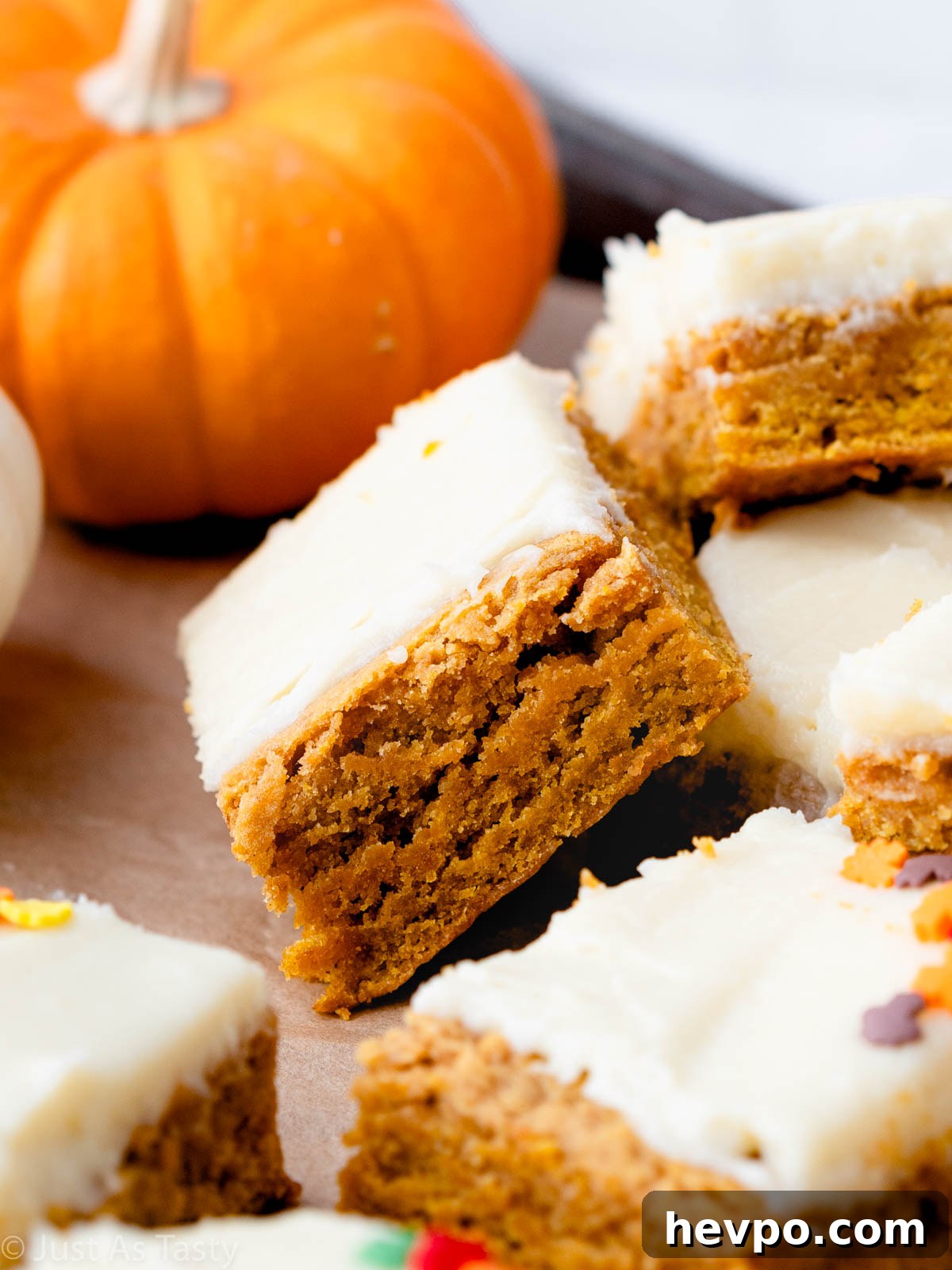 Gluten-Free Pumpkin Bars Recipe for Moist Spiced Squares 3 Close-up of a pumpkin bar topped with cream cheese frosting.