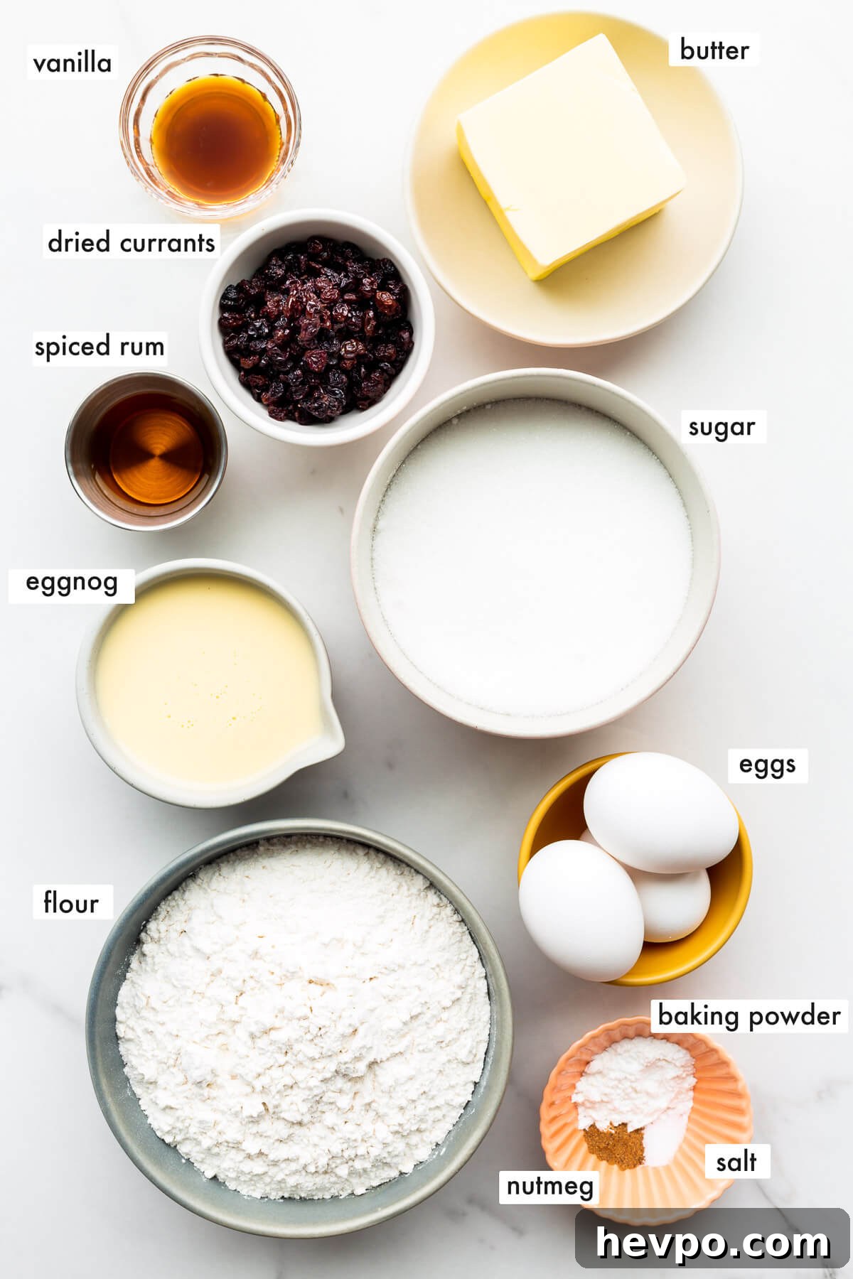 Ingredients to make an eggnog bundt cake with rum and dried currants.
