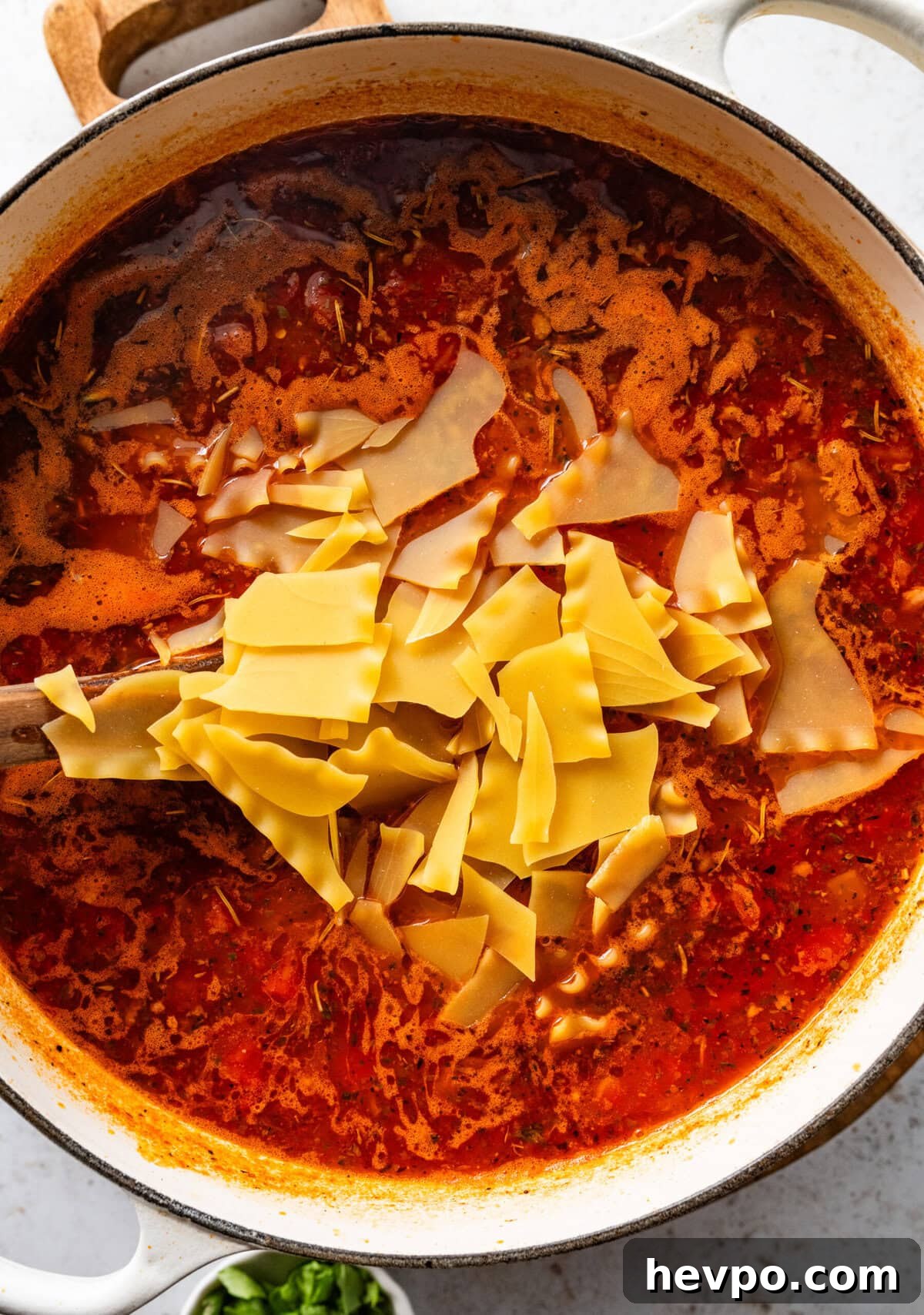 lasagna noodles added into the pot of lasagna soup.