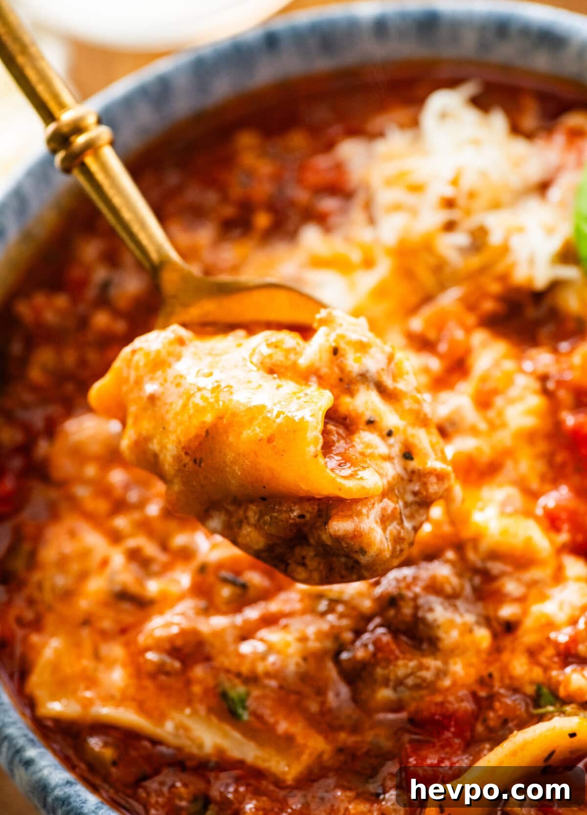 lasagna soup in a bowl with a spoon lifting a bite.