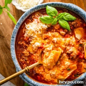 lasagna soup in a bowl with a spoon lifting a bite.