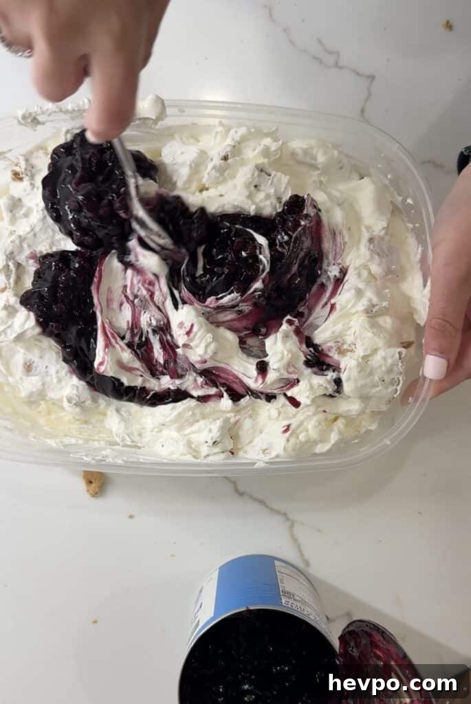 Blueberry Graham Cracker Swirl Ice Cream Recipe 3 mixing blueberry pie filling into the ice cream