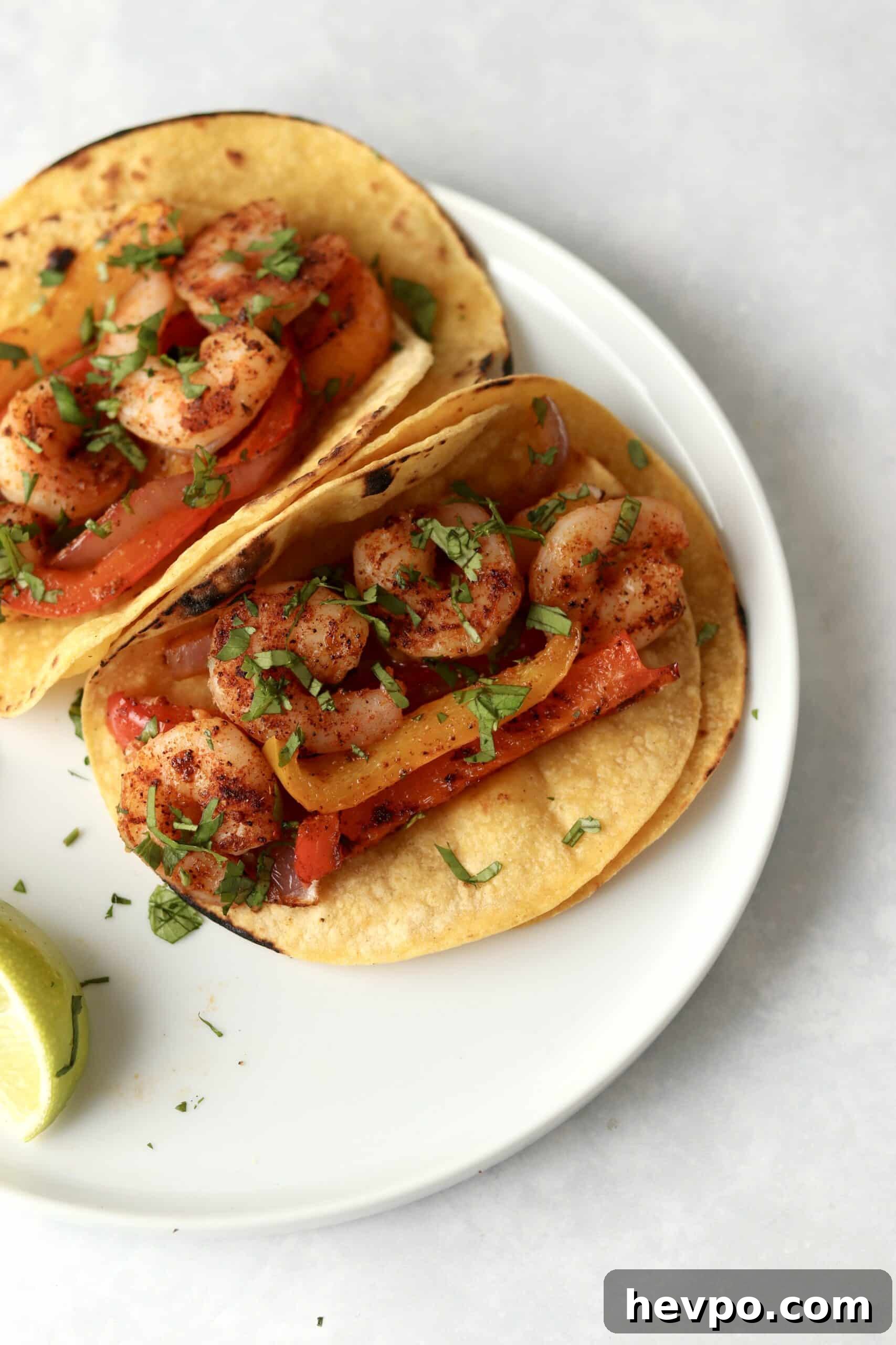 Sheet Pan Shrimp Fajitas with Peppers and Lime Butter 11 shrimp fajitas made in the oven on a plate