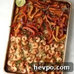 shrimp, peppers, and onions for fajitas on sheet pan