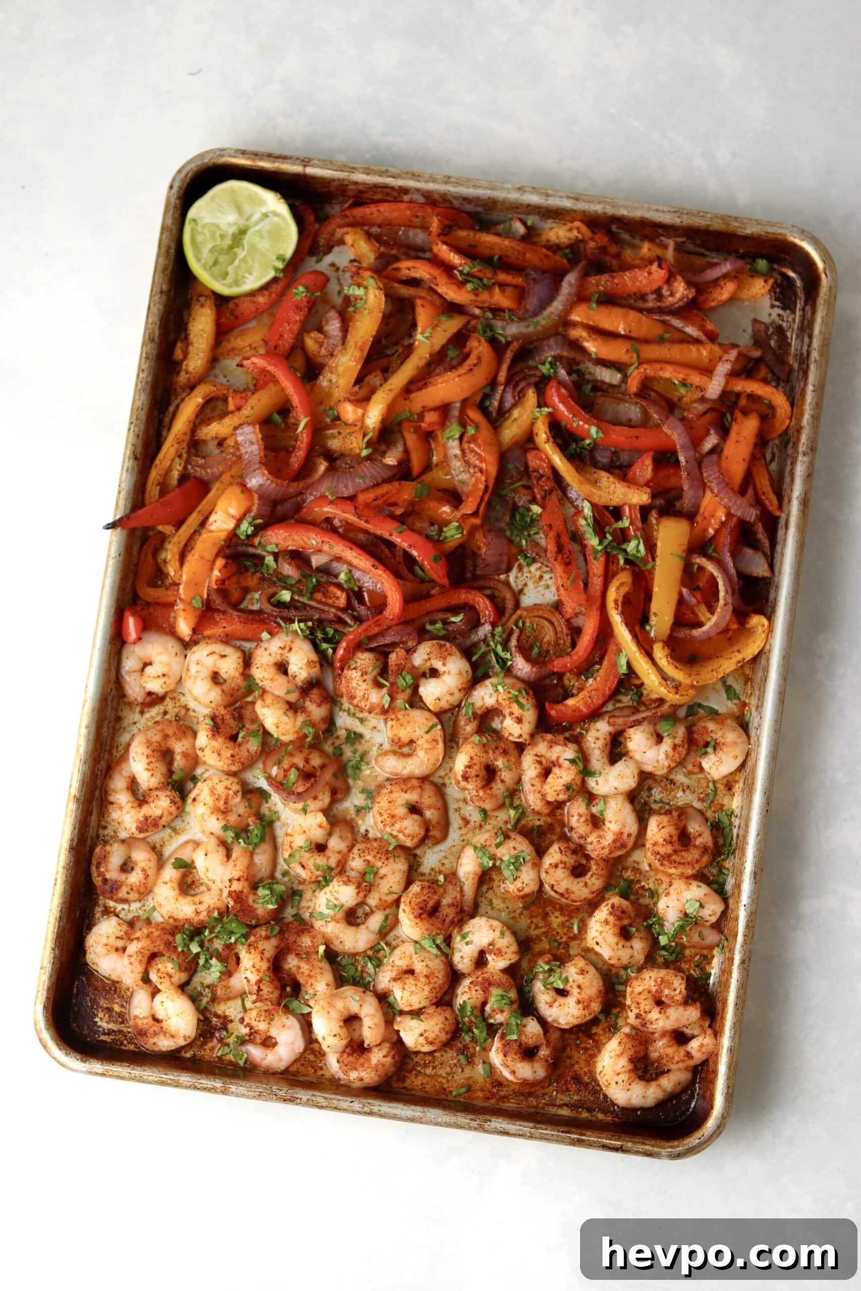 Sheet Pan Shrimp Fajitas with Peppers and Lime Butter 5 shrimp, peppers, and onions for fajitas on sheet pan