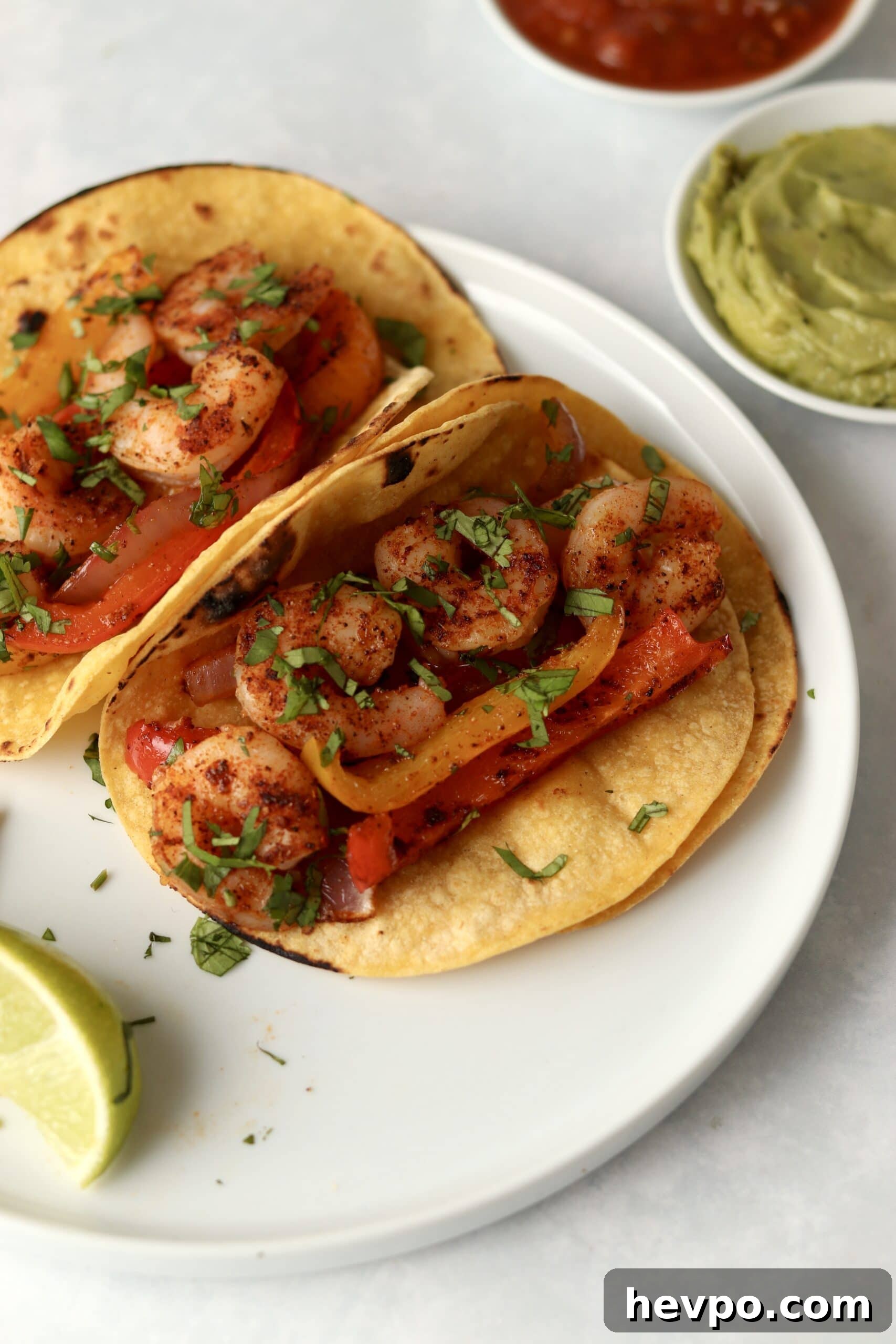 Sheet Pan Shrimp Fajitas with Peppers and Lime Butter 9 shrimp fajitas in tortillas with guacamole and salsa