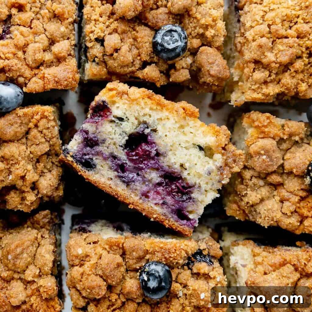 Maple Bacon Recipe with Just 2 Ingredients 11 A side view of a blueberry coffee cake slice in the middle of other coffee cake slices.