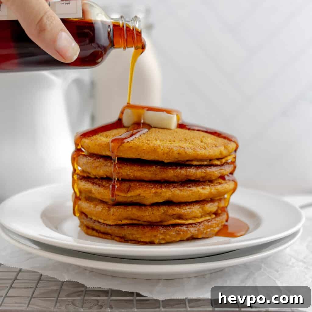 Maple Bacon Recipe with Just 2 Ingredients 12 Pouring maple syrup over a stack of pancakes topped with butter.