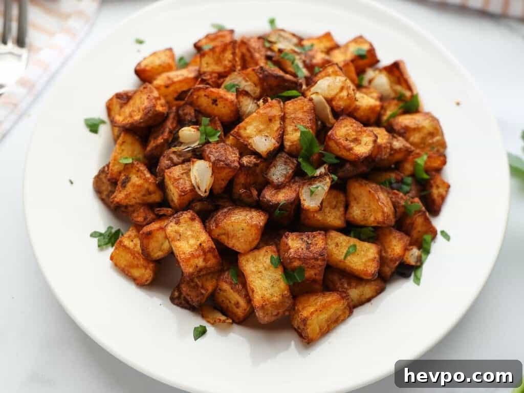 Maple Bacon Recipe with Just 2 Ingredients 14 A serving of breakfast potatoes on a white plate.