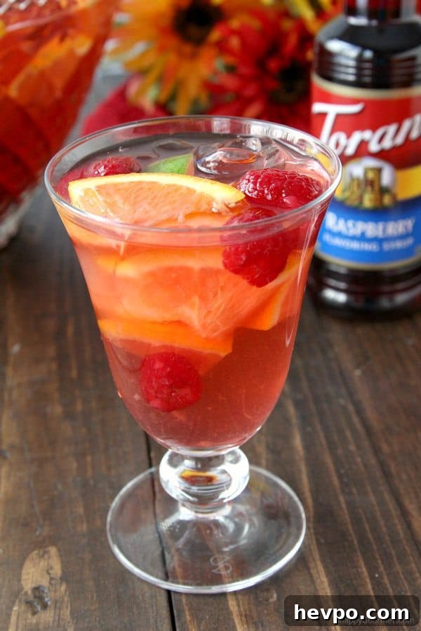 Refreshing Raspberry Sangria Punch Recipe for Parties 8 Raspberry Sangria Punch, easy white wine sangria drink recipe great for a holiday party! SnappyGourmet.com