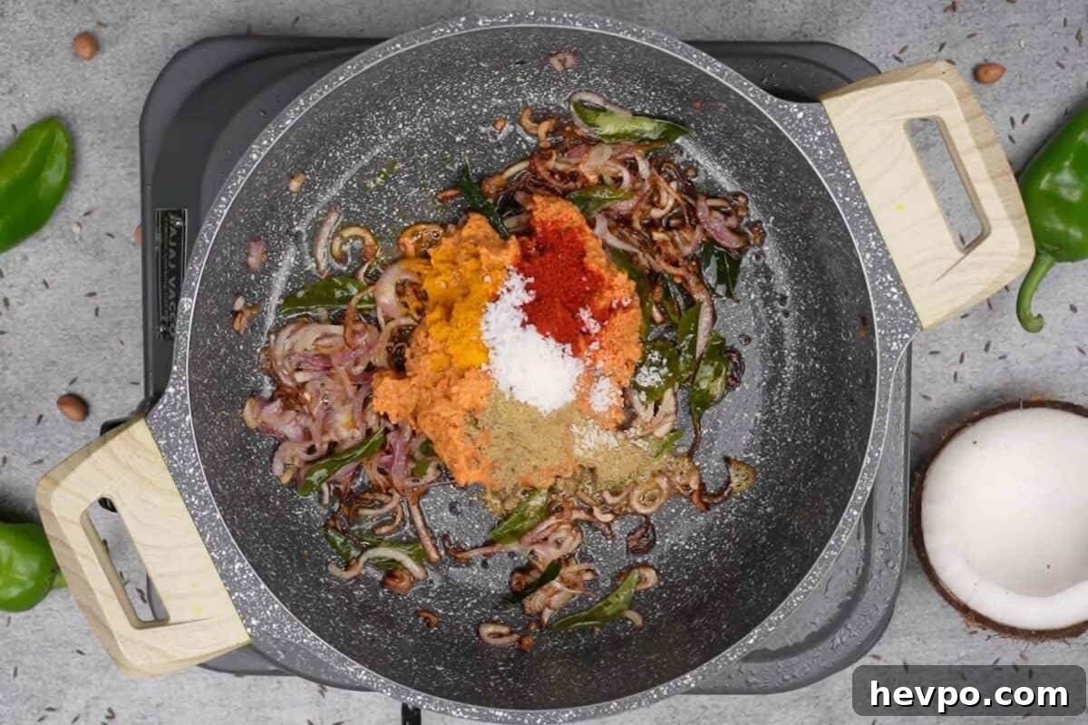 Mirchi Ka Salan (Biryani Salan) Recipe — Spicy Hyderabadi Chili Curry 8 Salan paste and spice powders added to the pan.
