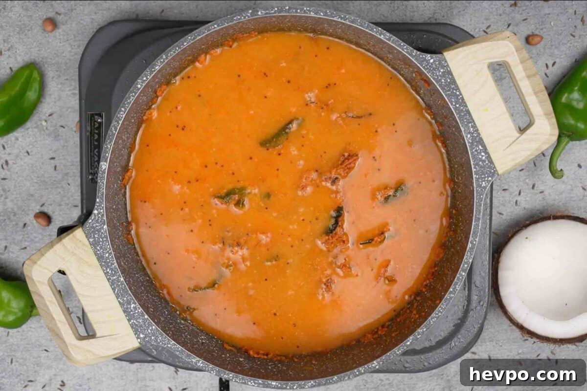 Mirchi Ka Salan (Biryani Salan) Recipe — Spicy Hyderabadi Chili Curry 9 Water added to the pan.