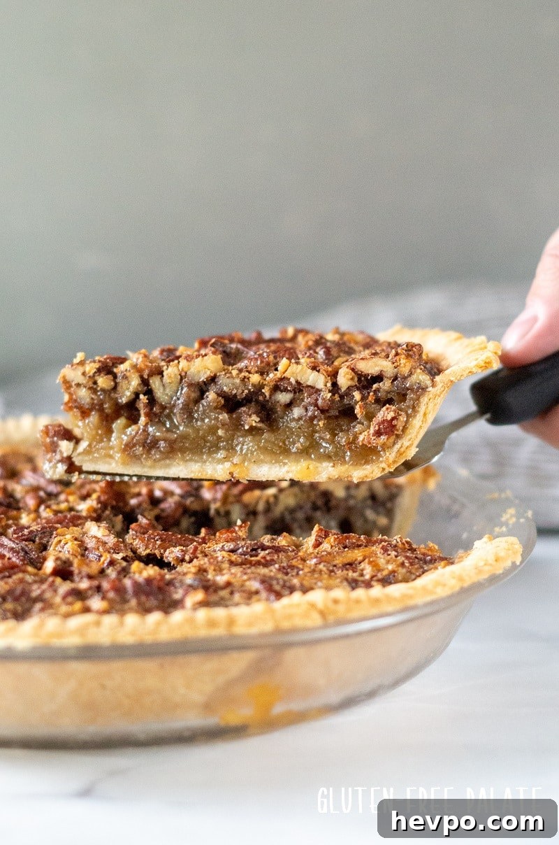 Gluten-Free Pecan Pie Recipe — Classic Southern Dessert 4 a slice of gluten free pecan pie on a pie server