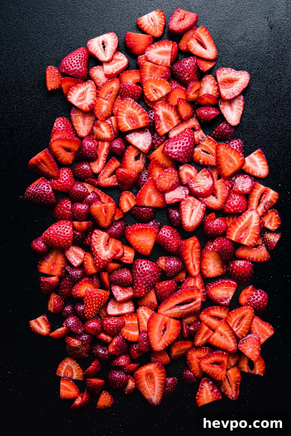 Roasted Strawberries: How to Cook and Use Them for Bold Flavor 5 strawberry slices on a black cutting board