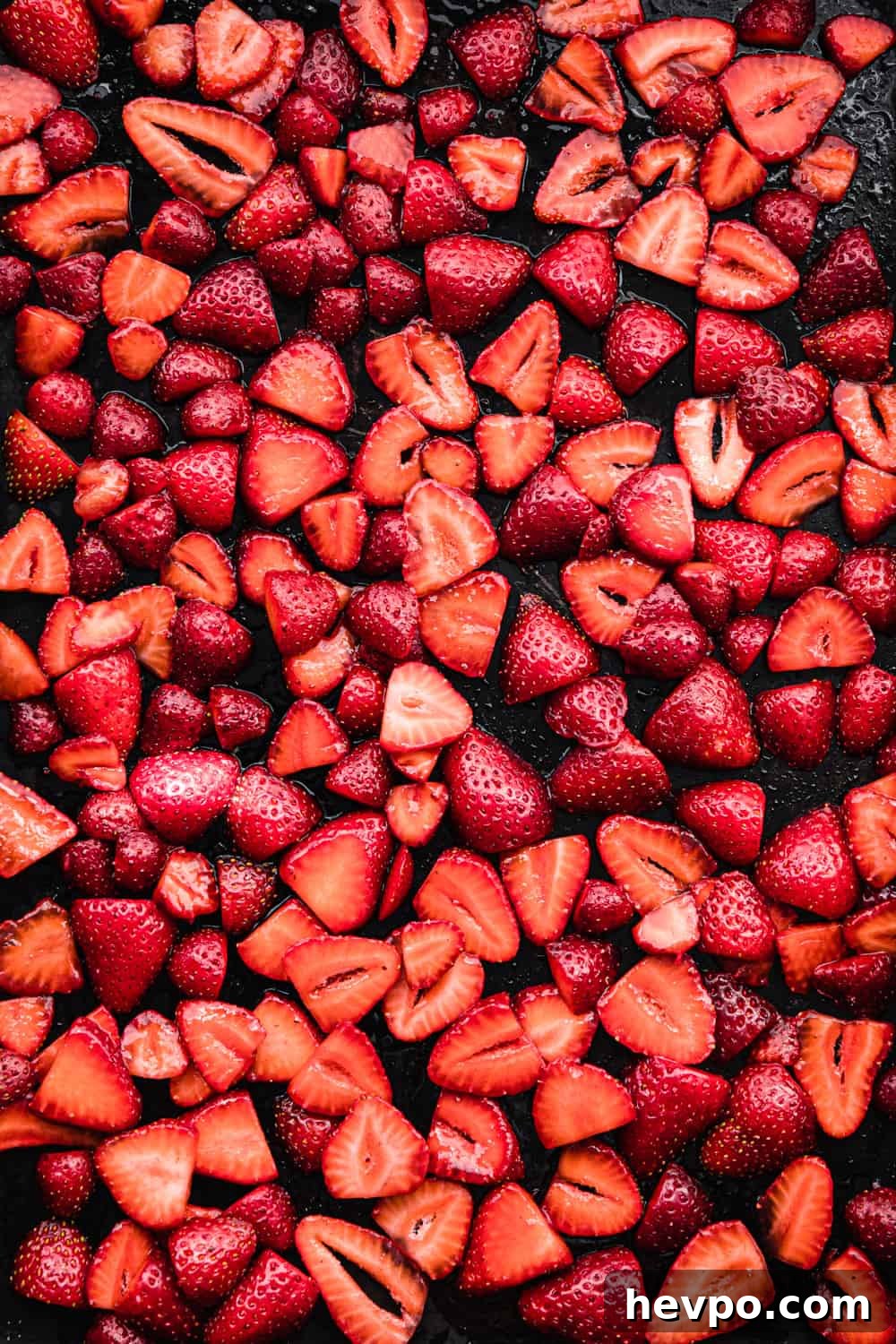 Roasted Strawberries: How to Cook and Use Them for Bold Flavor 6 sliced strawberries on a baking sheet