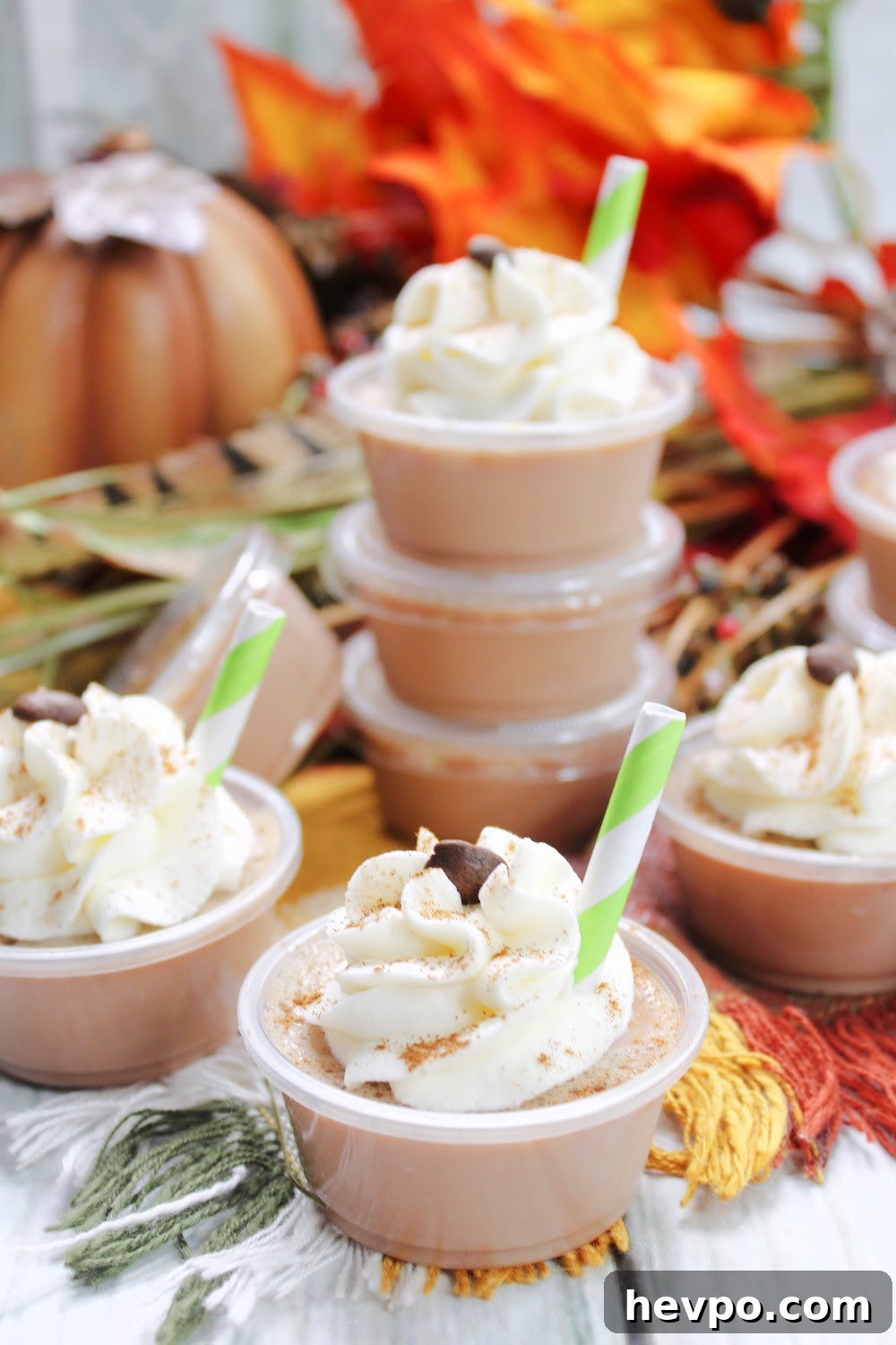 A tray of a yummy pumpkin spice latte jello shots topped with whipped cream and dusted with cinnamon!
